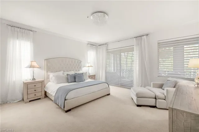 a large white bathroom with a bathtub a sink a window and a shower