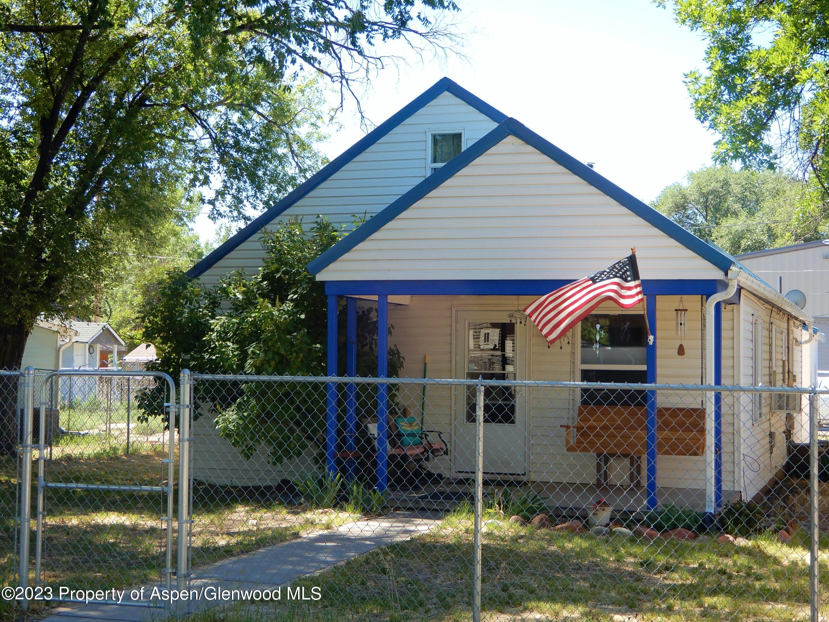 129 East 11th Street Rifle, CO 81650 - Photo 1 of 24 a view of a small house next to a yard