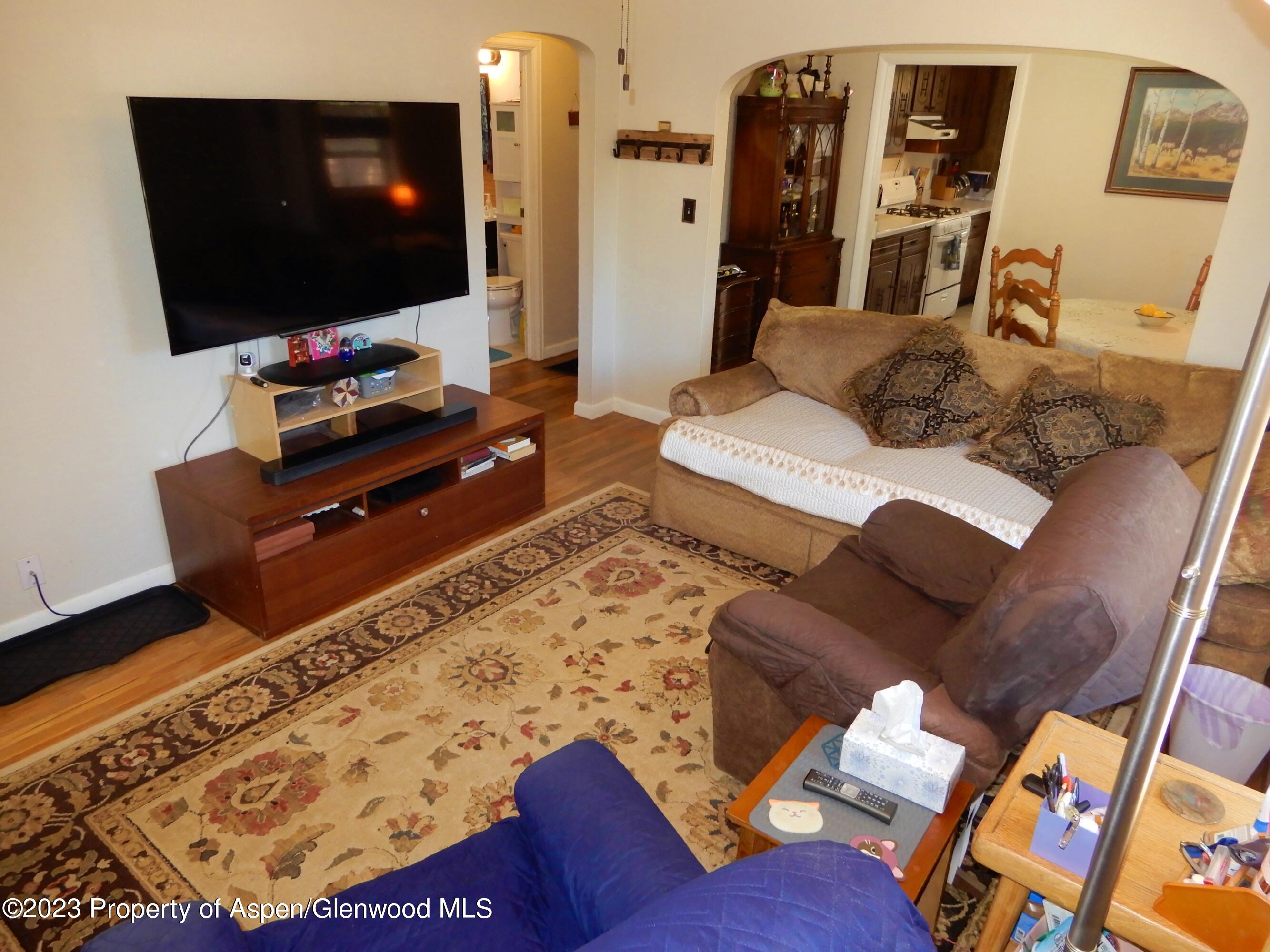129 East 11th Street Rifle, CO 81650 - Photo 7 of 24 a living room with furniture and a flat screen tv
