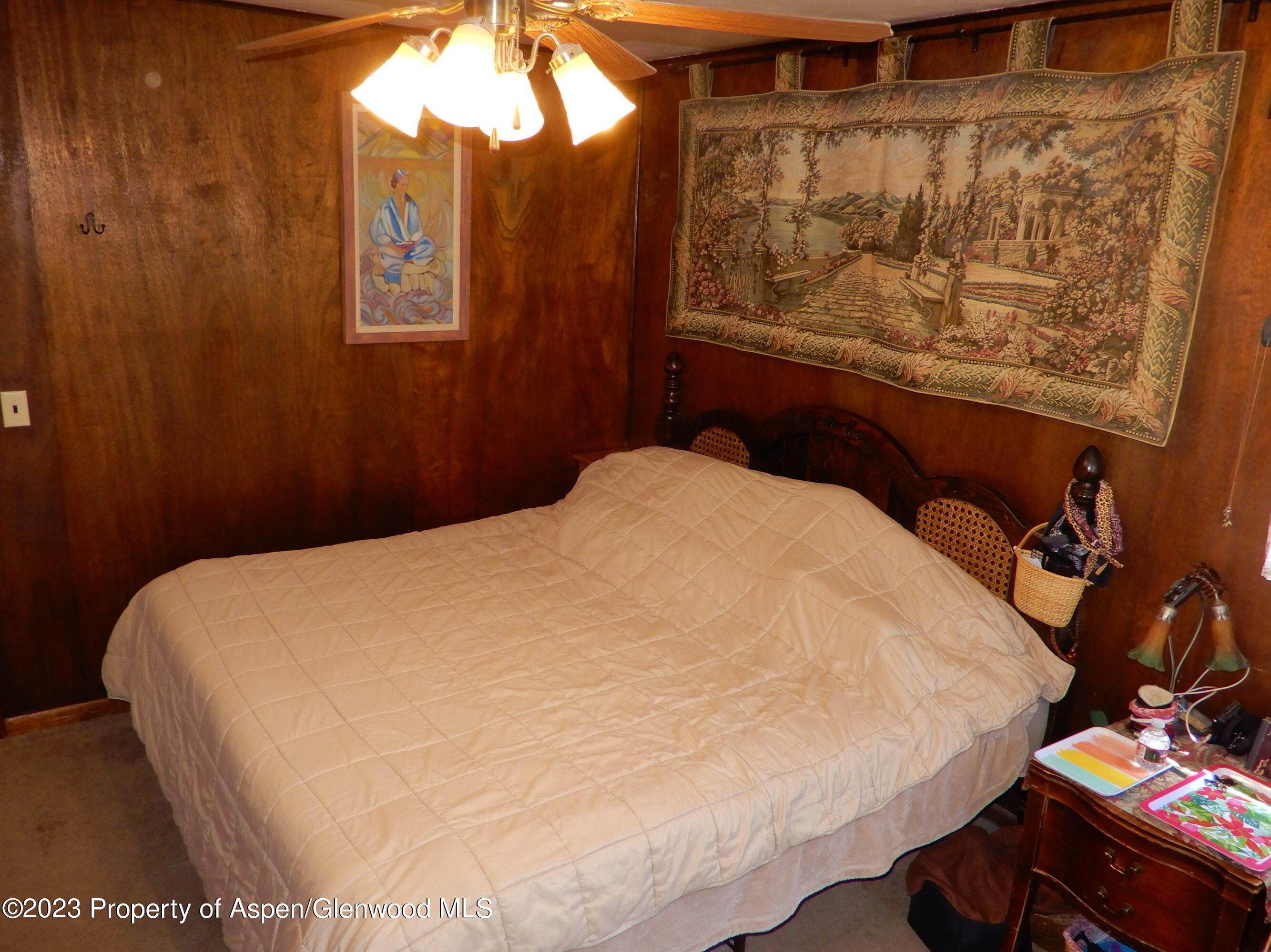 129 East 11th Street Rifle, CO 81650 - Photo 8 of 24 a bed sitting in a bedroom next to a window