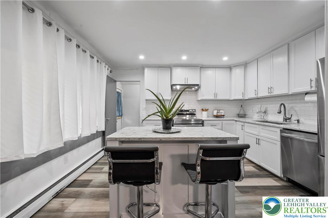 148 North 8th Street Coplay, PA 18037 - Photo 16 of 45 a kitchen with stainless steel appliances granite countertop a sink a stove a refrigerator and cabinets