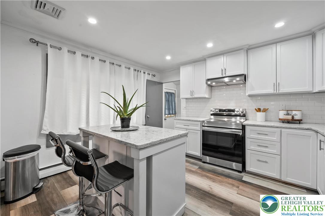 148 North 8th Street Coplay, PA 18037 - Photo 17 of 45 a kitchen with stainless steel appliances a sink a stove a refrigerator cabinets and dining table