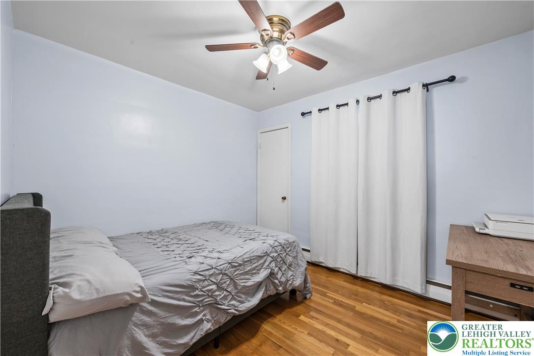 148 North 8th Street Coplay, PA 18037 - Photo 23 of 45 a bedroom with a bed and a chandelier