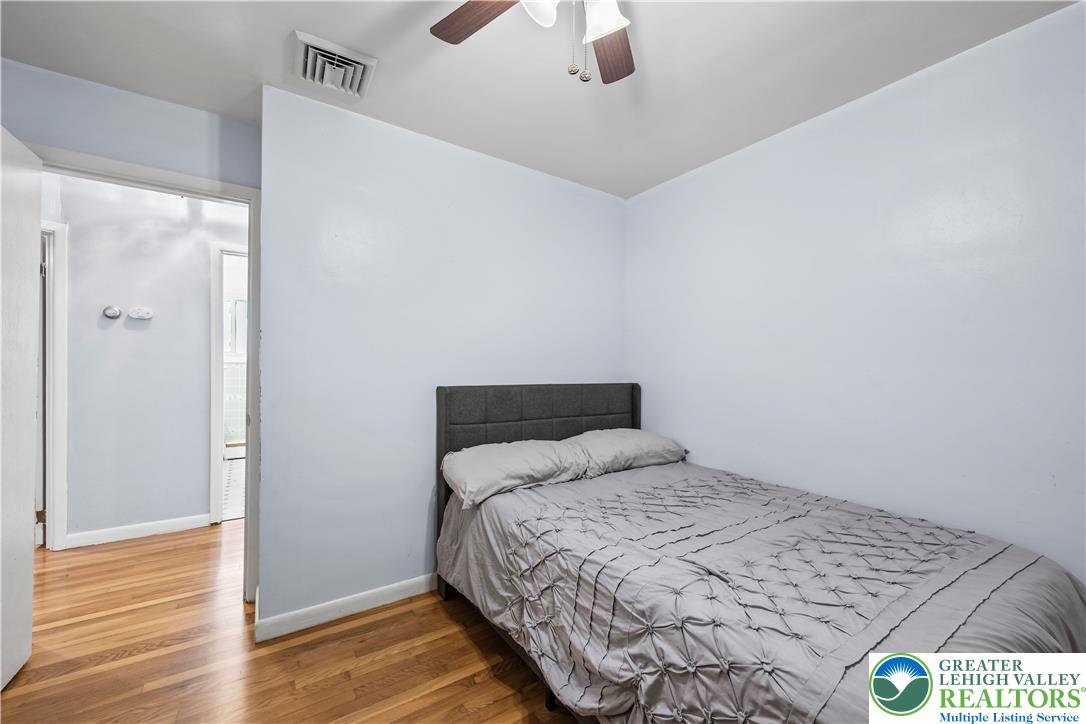 148 North 8th Street Coplay, PA 18037 - Photo 24 of 45 a bedroom with a bed and wooden floor