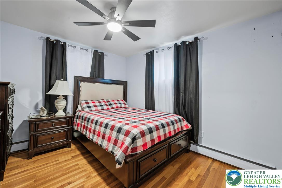 148 North 8th Street Coplay, PA 18037 - Photo 27 of 45 a bedroom with a bed wall painting on the wall and a large window