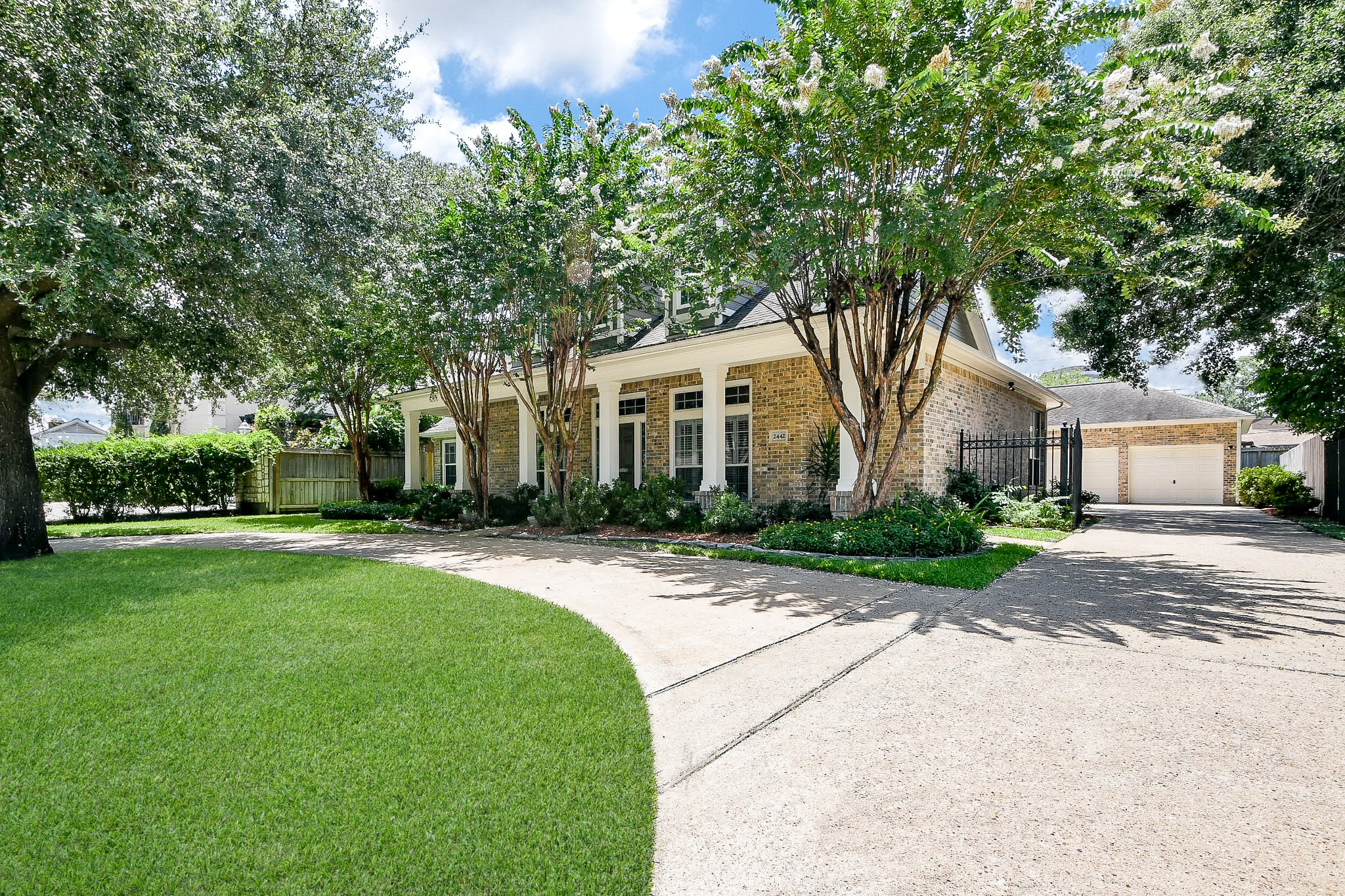 a front view of a house with a yard and trees
