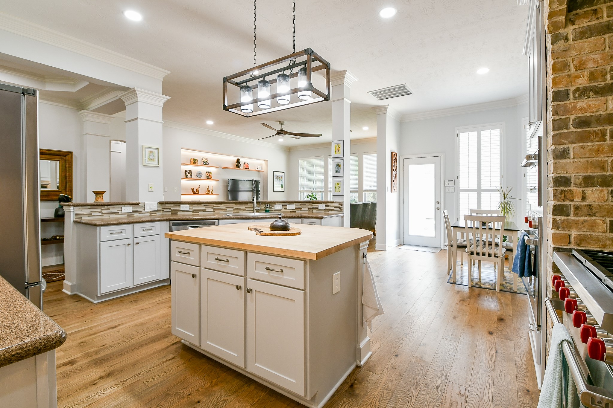 2442 Chimney Rock Road Houston, TX 77057 - Photo 14 of 50 a kitchen with a stove cabinets and wooden floor