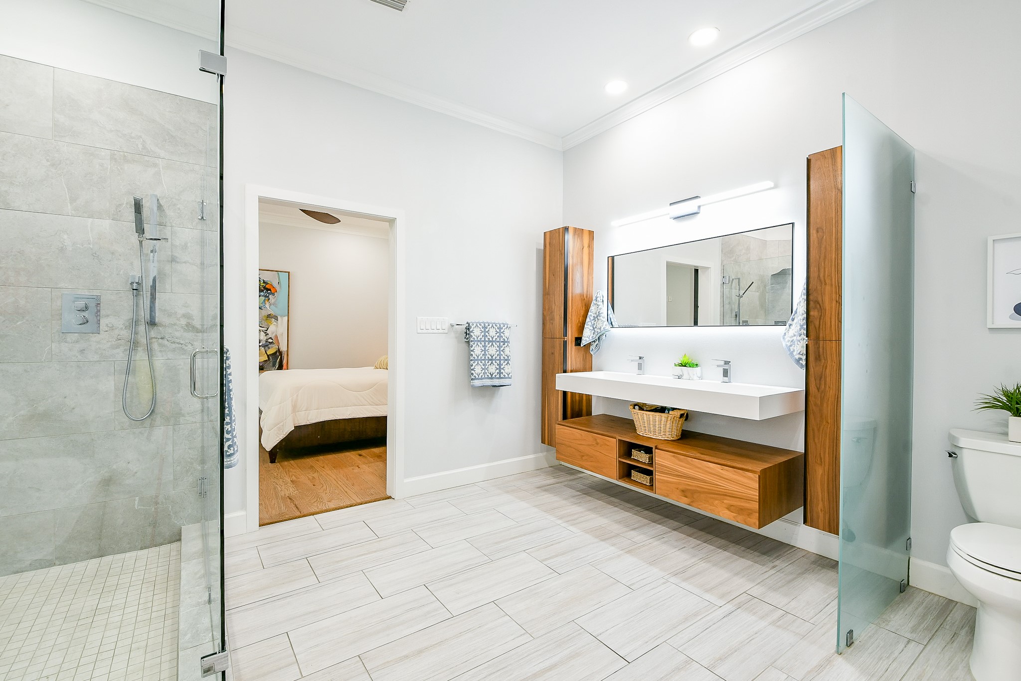 2442 Chimney Rock Road Houston, TX 77057 - Photo 32 of 50 a bathroom with a tub and a glass door shower