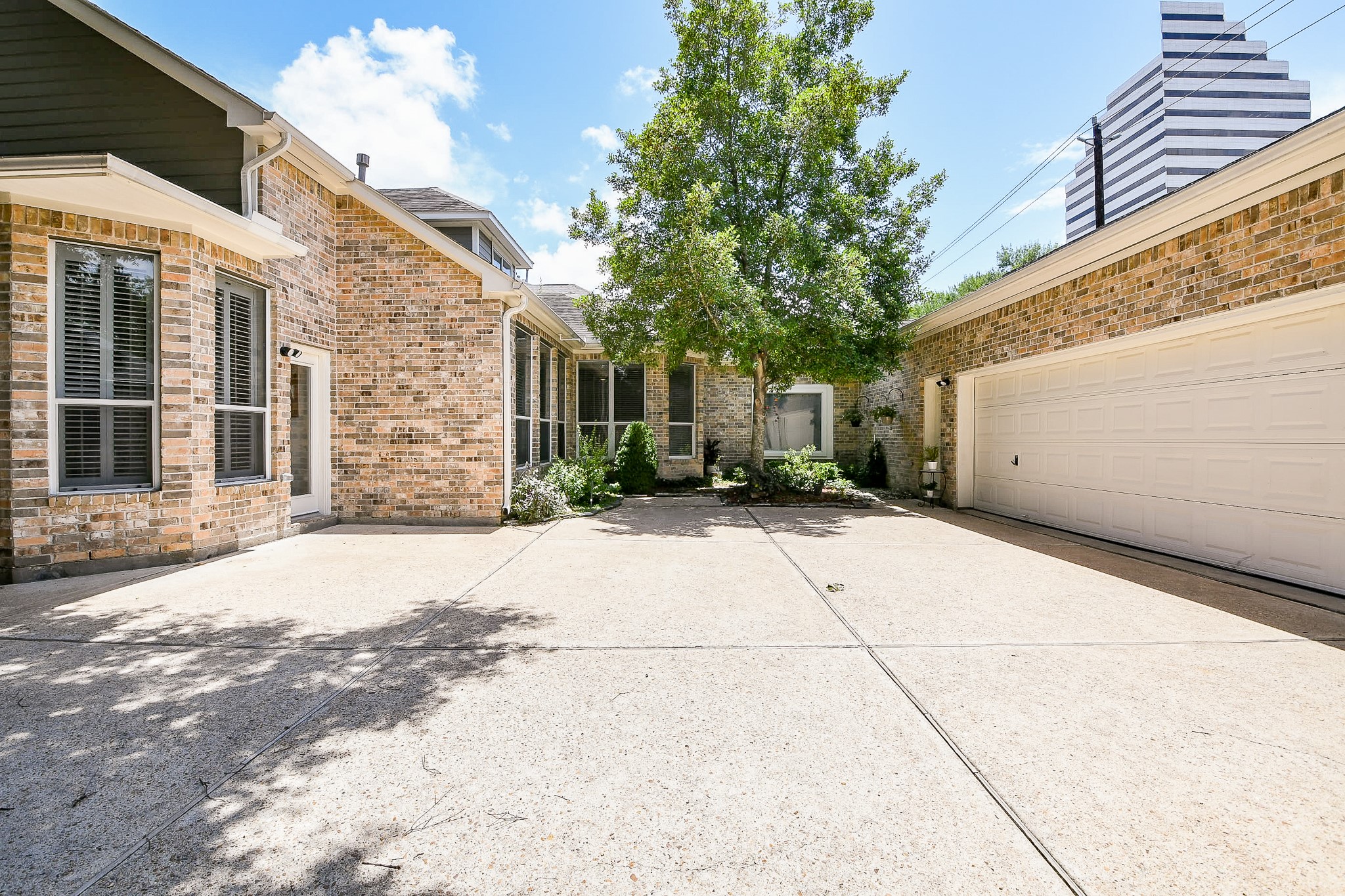 2442 Chimney Rock Road Houston, TX 77057 - Photo 50 of 50 a view of a parking space in a house with potted plants