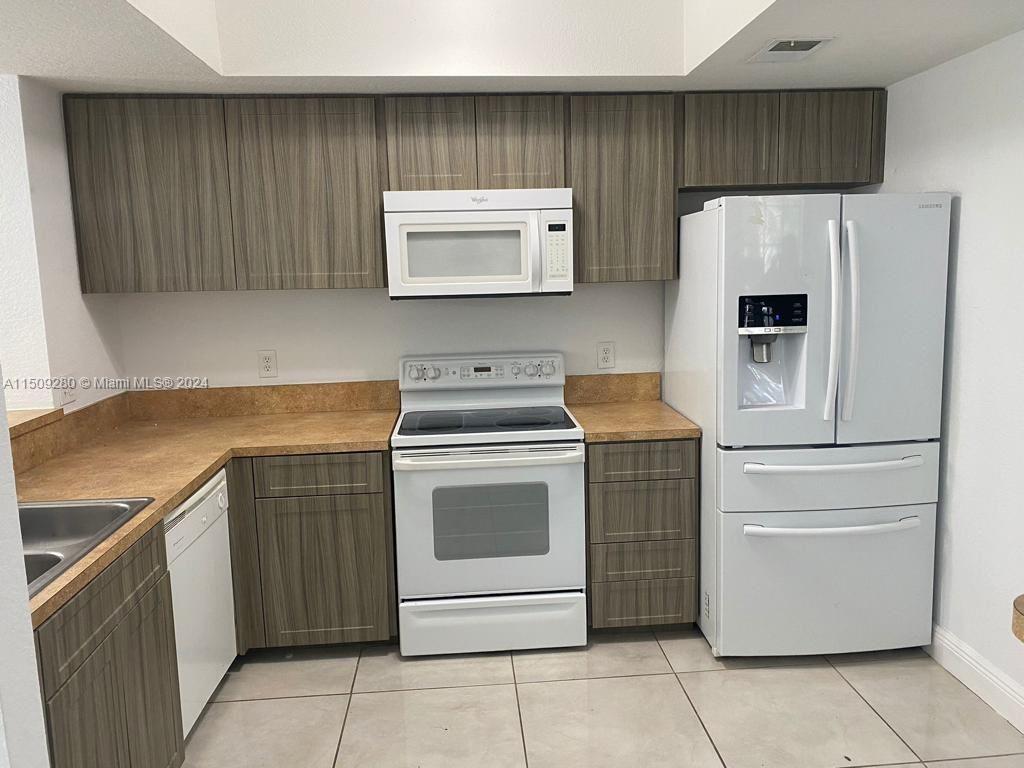 a kitchen with a stove refrigerator and cabinets