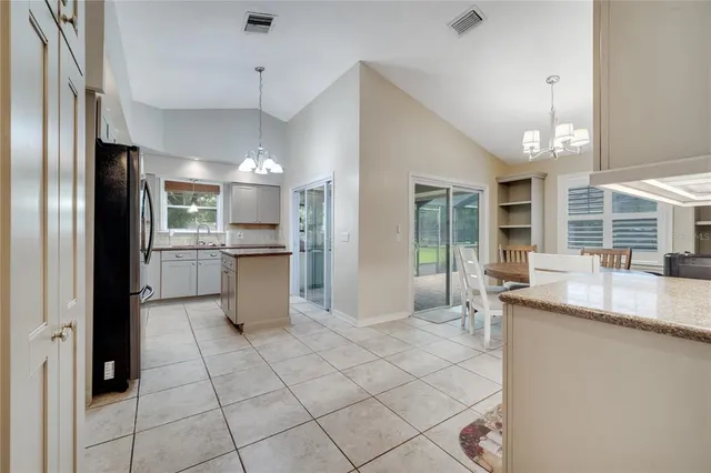 a kitchen with stainless steel appliances granite countertop a refrigerator and a sink