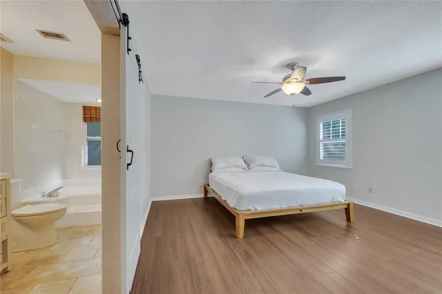 a bedroom with a bed and a chandelier