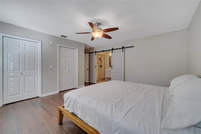 a bedroom with a bed and a chandelier
