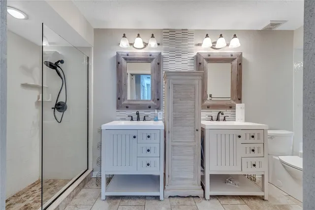 a bathroom with double vanity sink a mirror and bathtub