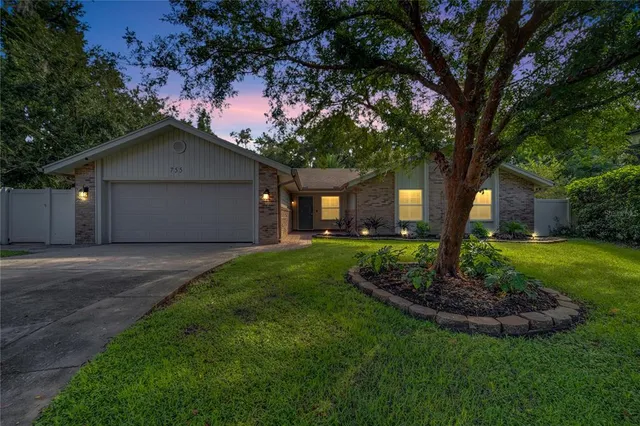 a front view of a house with a garden