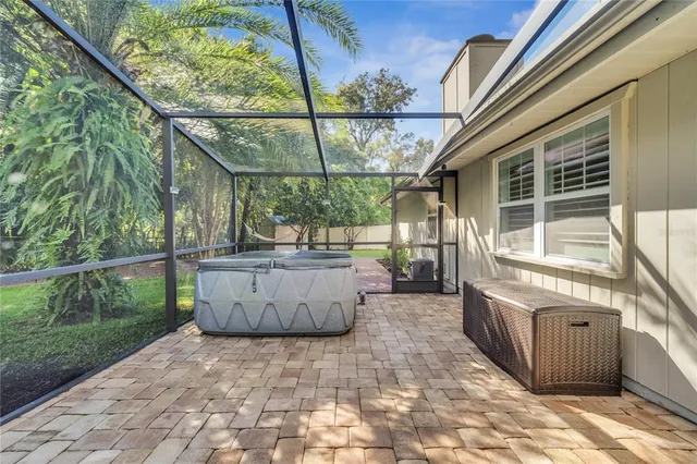 a view of a patio with wooden fence and a bench