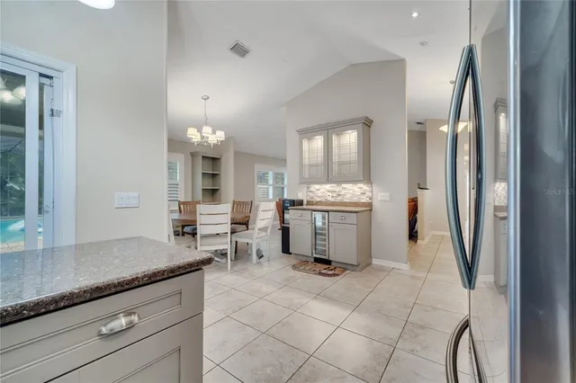 a kitchen with granite countertop a sink cabinets and stainless steel appliances