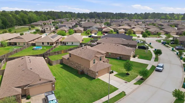 an aerial view of a house with outdoor space