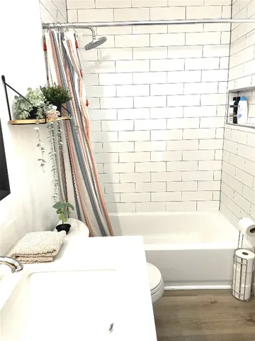 a bathroom with a bathtub and shower