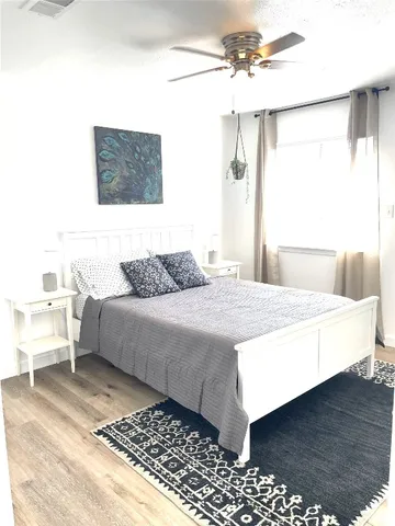 a bedroom with a bed and a chandelier