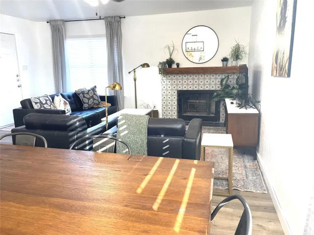 a living room with furniture a clock and a fireplace