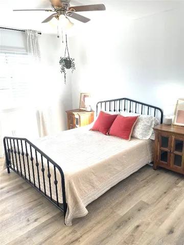 a large bed sitting in a bedroom next to a window