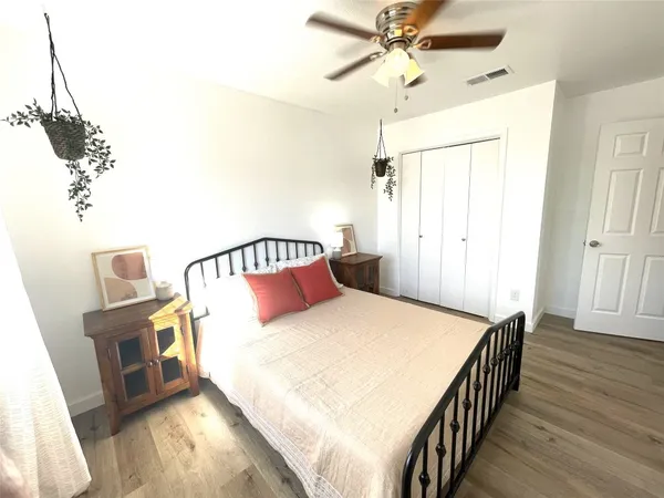 a bedroom with a bed and wooden floor