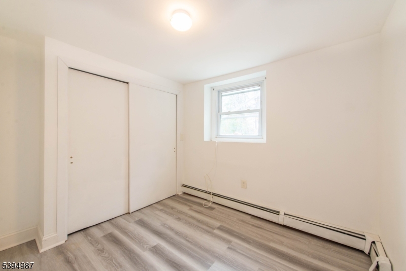 233 Lakeside Avenue Hopatcong, NJ 07821 - Photo 3 of 9 an empty room with a empty space and a window