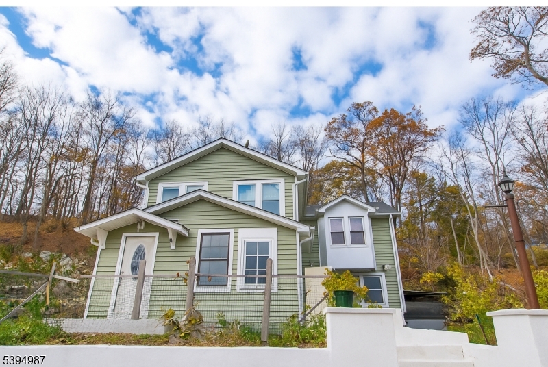 233 Lakeside Avenue Hopatcong, NJ 07821 - Photo 5 of 9 a front view of a house with garden