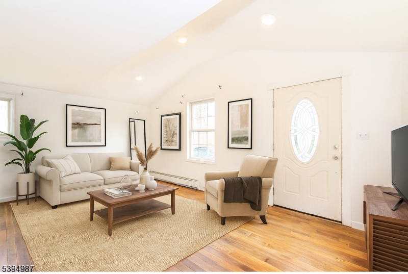233 Lakeside Avenue Hopatcong, NJ 07821 - Photo 6 of 9 a living room with furniture a rug a lamp and a large window