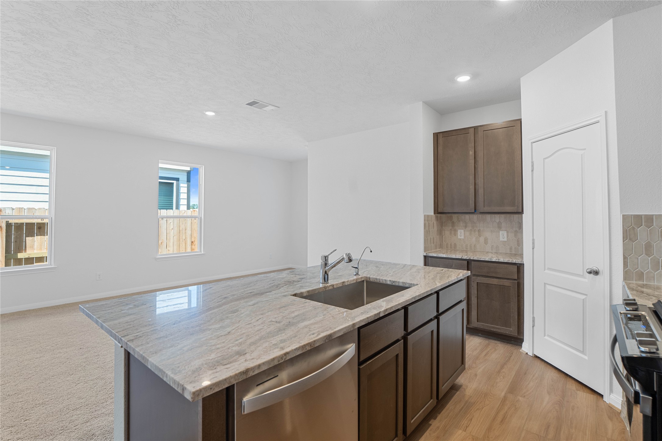 6423 Kentfield Drive Rosharon, TX 77583 - Photo 16 of 26 Additional view of the kitchen island displaying the ample storage space and gorgeous granite countertop.