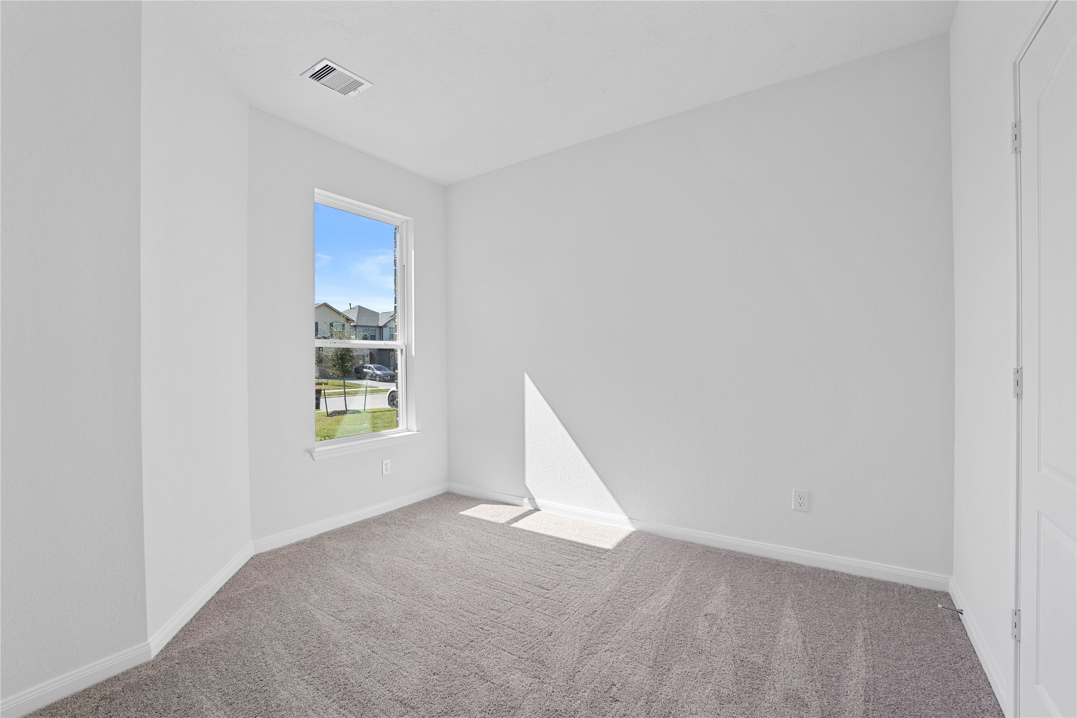6423 Kentfield Drive Rosharon, TX 77583 - Photo 9 of 26 Tucked peacefully in the front of the home, this secondary bedroom offers comfort and style with plush carpeting, neutral paint tones, recessed lighting, a large window, and a generously sized closet