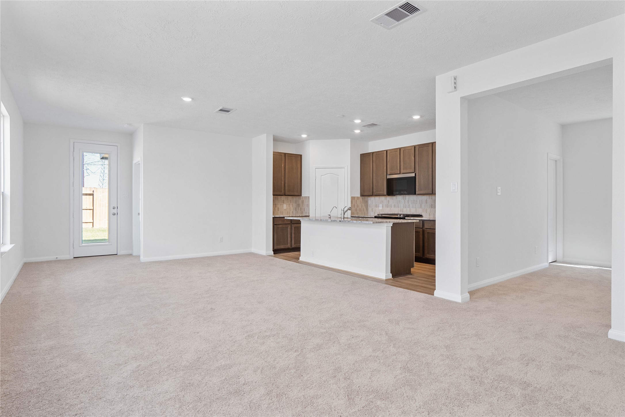 6423 Kentfield Drive Rosharon, TX 77583 - Photo 10 of 26 Stunning open-concept design seamlessly connecting the living, dining, and kitchen areas—perfect for both everyday living and entertaining!