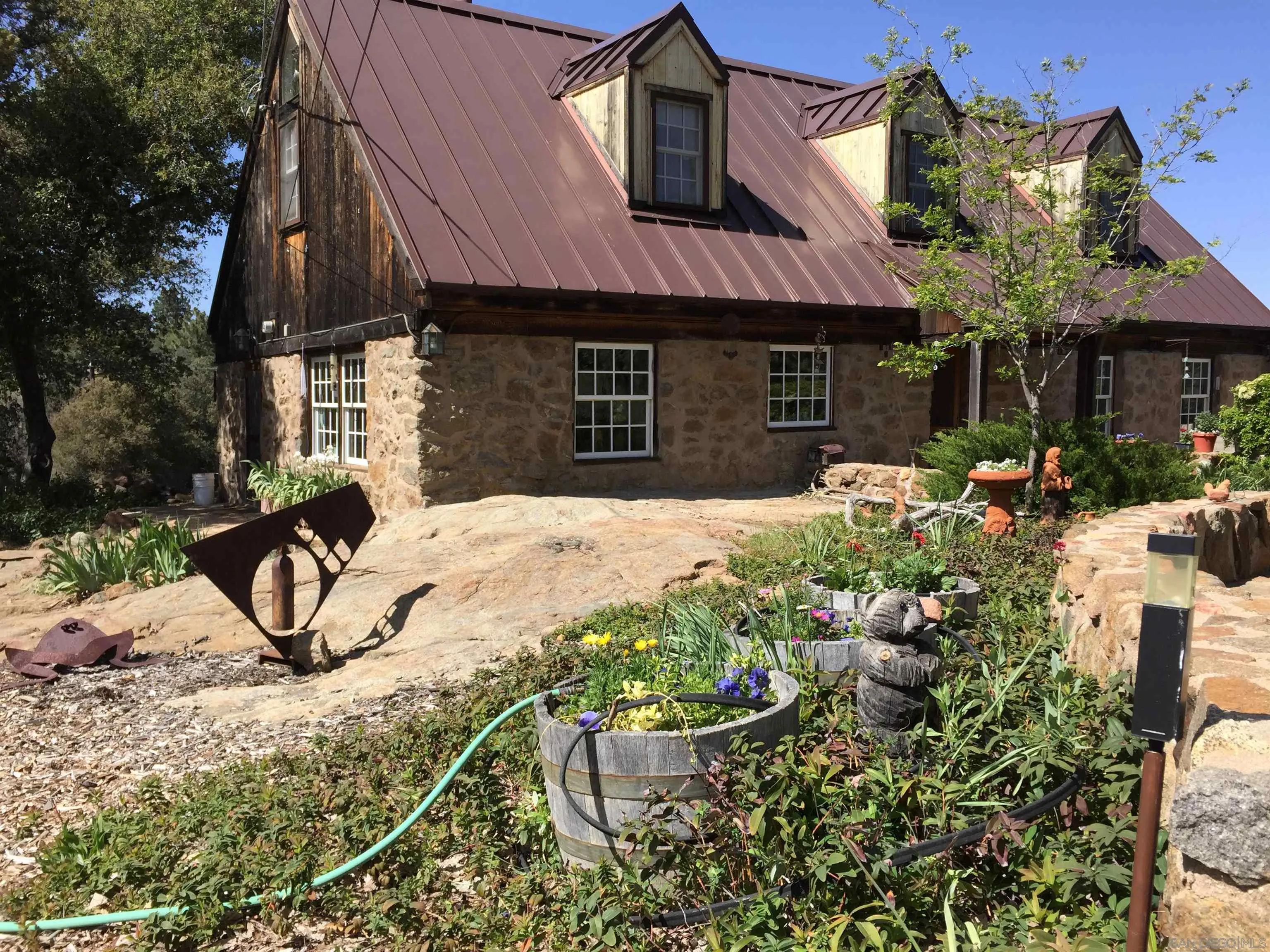 a view of a house with yard and sitting area