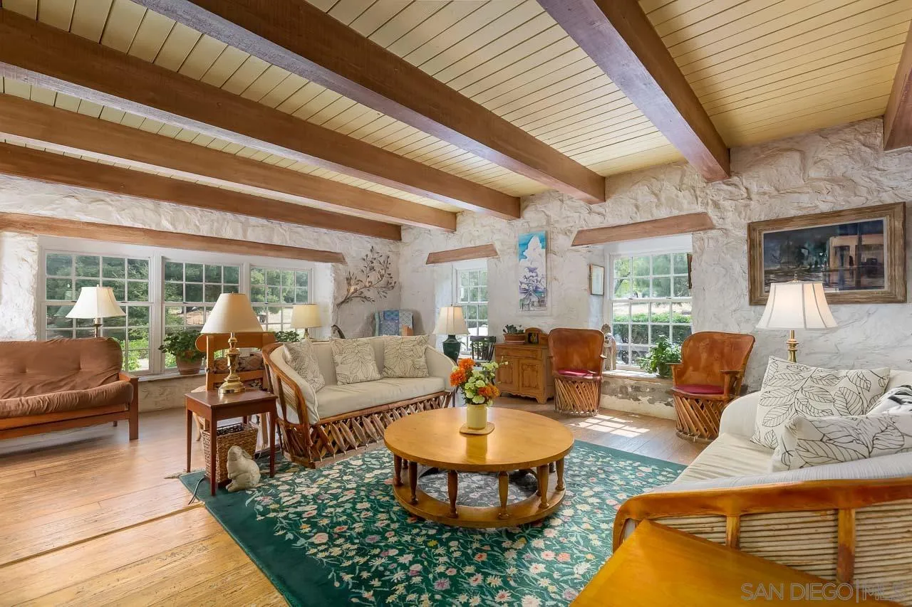 3754 Pine Hills Road Julian, CA 92036 - Photo 8 of 39 a living room with furniture a rug potted plant and a large window