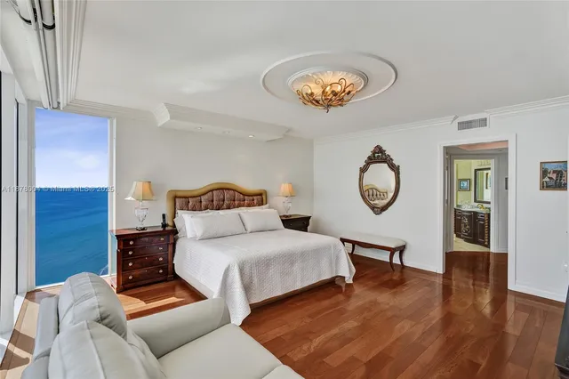 a view of a room with wooden floor and windows