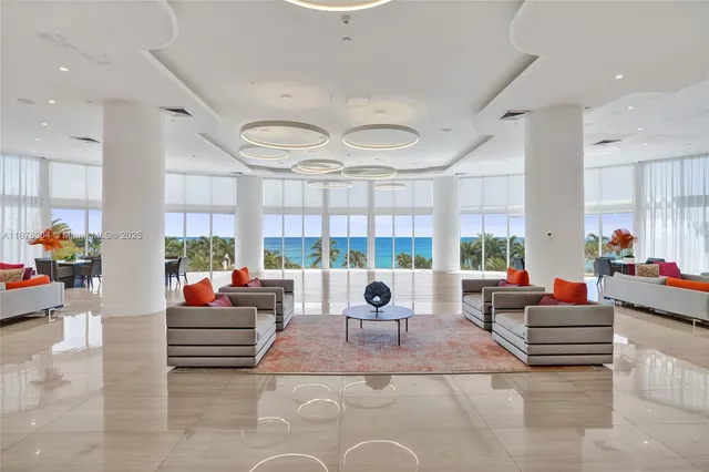 a view of swimming pool with outdoor seating and lake in the back