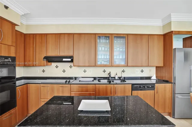 a kitchen with stainless steel appliances granite countertop sink stove top oven and cabinets