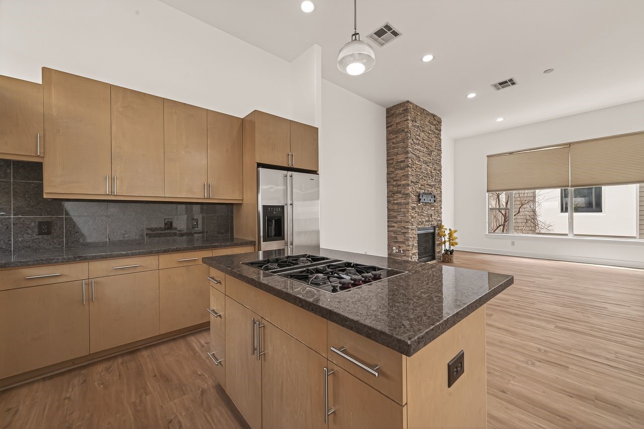 724 Ruthven Street Houston, TX 77019 - Photo 13 of 45 a kitchen with granite countertop a sink a counter space and cabinets