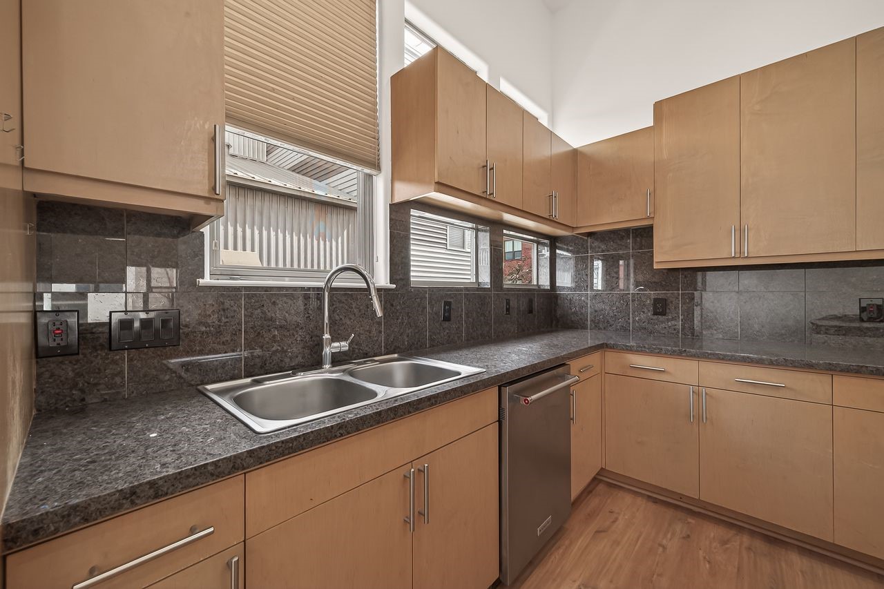 724 Ruthven Street Houston, TX 77019 - Photo 20 of 45 a kitchen with granite countertop a sink and cabinets