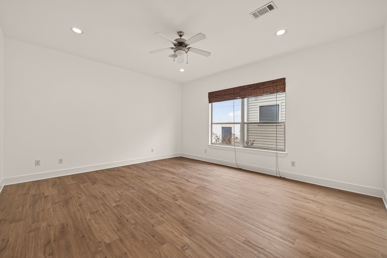 724 Ruthven Street Houston, TX 77019 - Photo 21 of 45 wooden floor in an empty room with a window