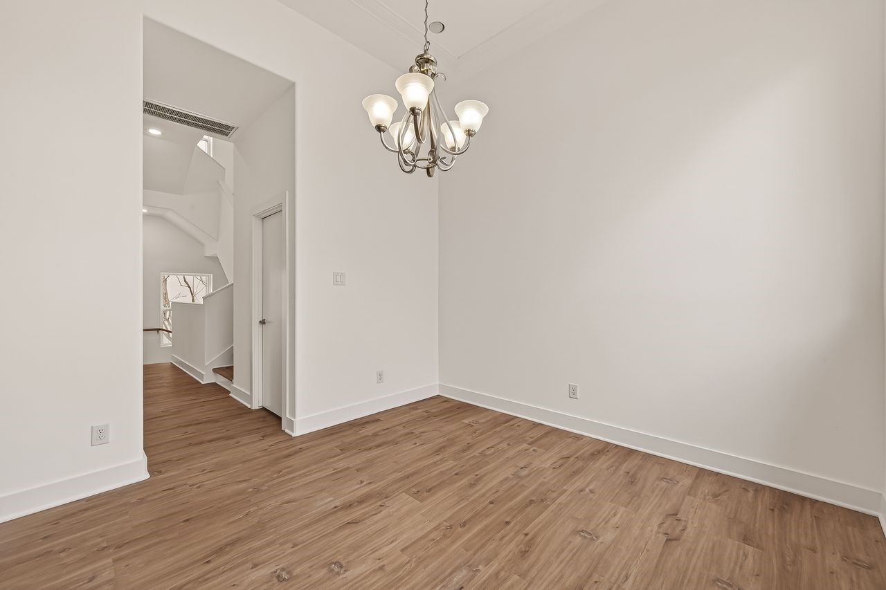 724 Ruthven Street Houston, TX 77019 - Photo 22 of 45 an empty room with wooden floor