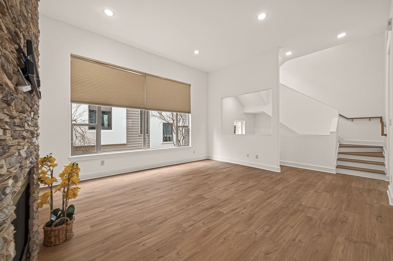 724 Ruthven Street Houston, TX 77019 - Photo 26 of 45 a view of an empty room with a window and wooden floor
