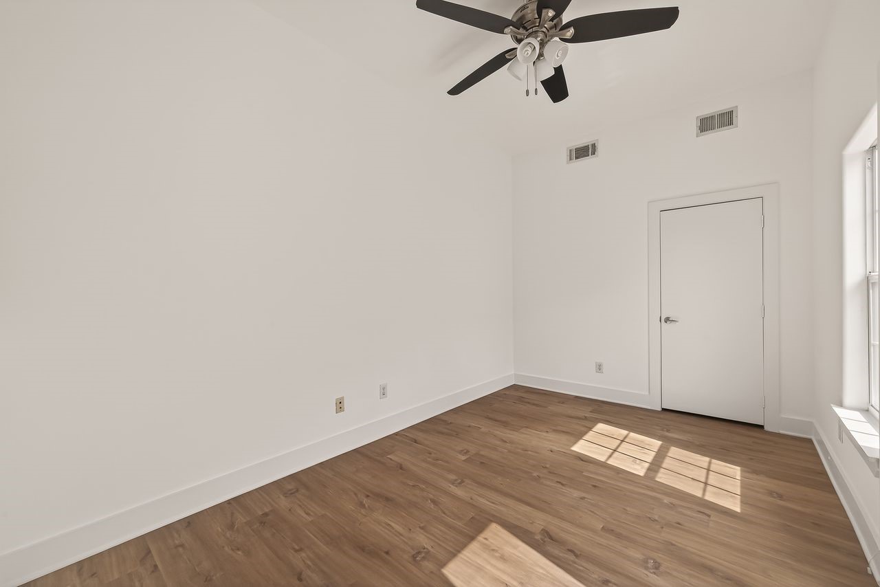 724 Ruthven Street Houston, TX 77019 - Photo 29 of 45 a view of a room with wooden floor and white walls