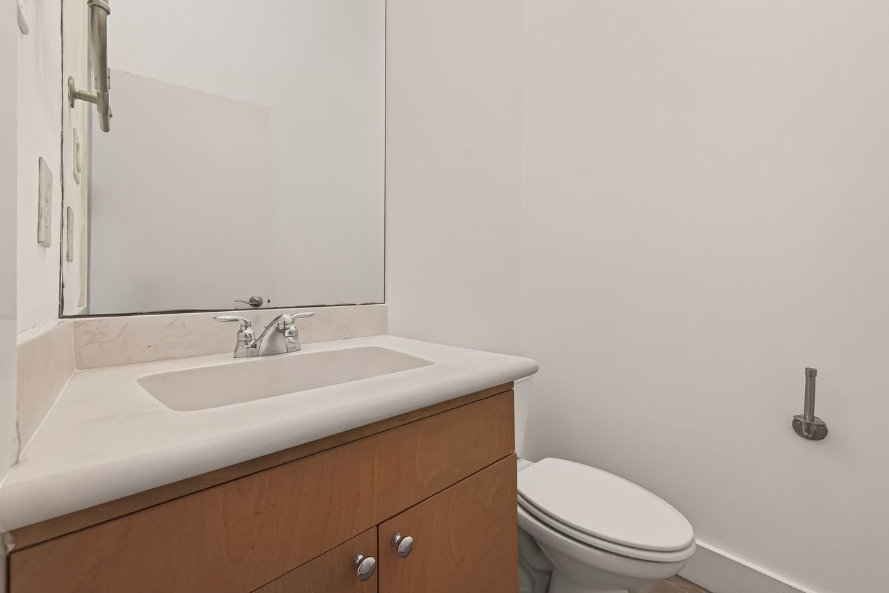 724 Ruthven Street Houston, TX 77019 - Photo 37 of 45 a bathroom with a granite countertop sink toilet and mirror