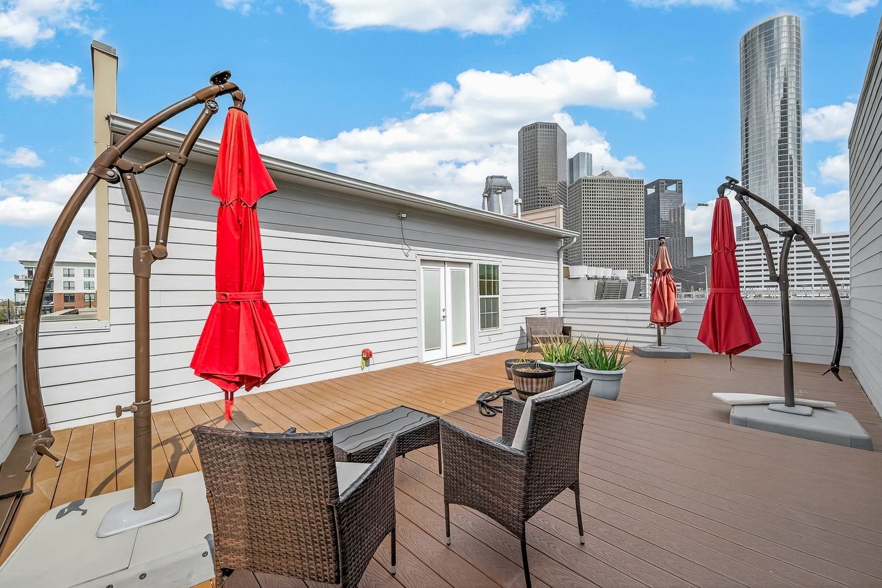 724 Ruthven Street Houston, TX 77019 - Photo 44 of 45 a view of roof deck with a table and chairs