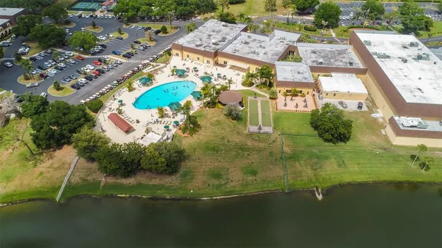 an aerial view of residential houses with outdoor space and swimming pool