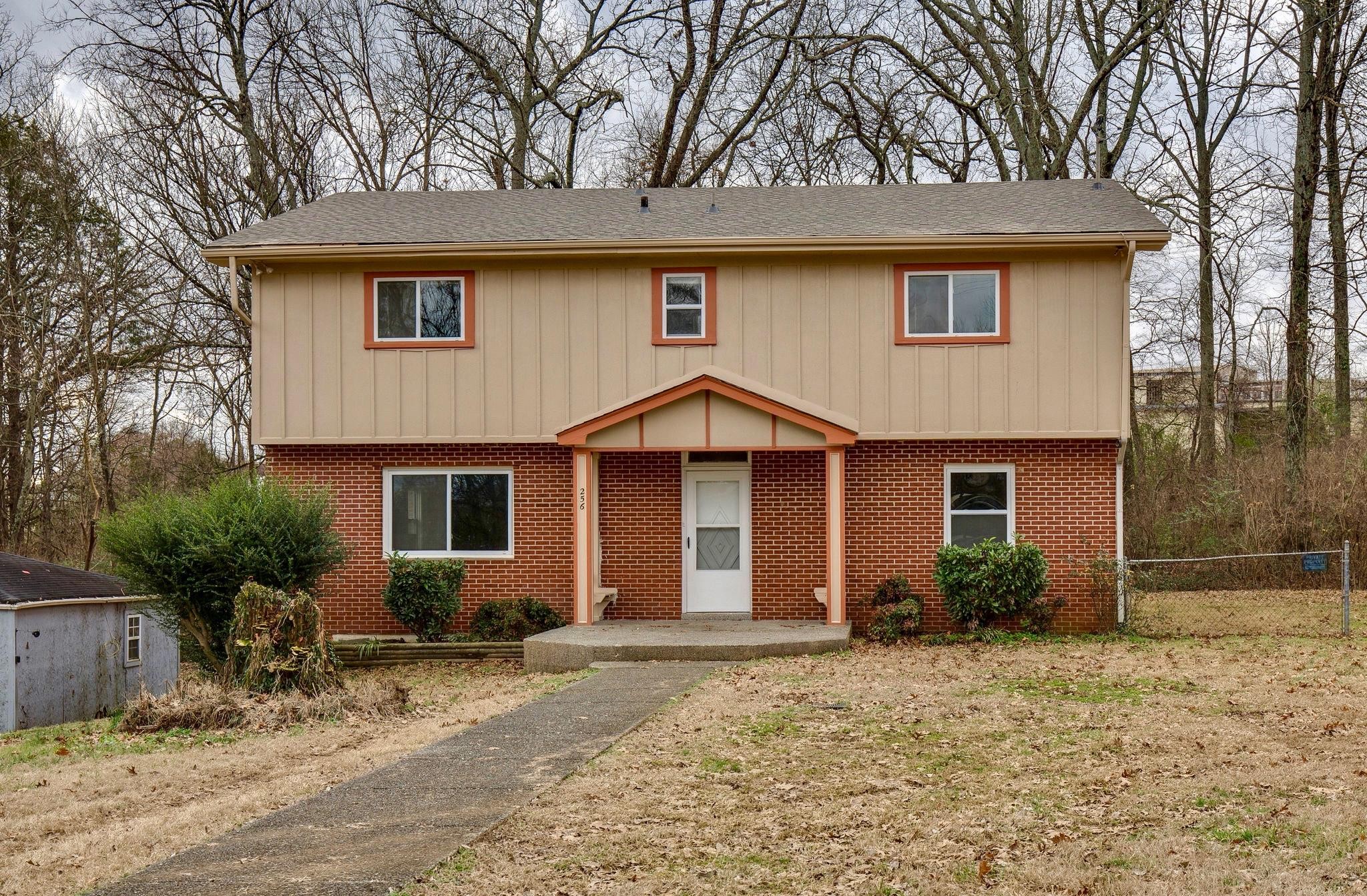 256 Manzano Road Madison, TN 37115 - Photo 1 of 24 a front view of a house with garden