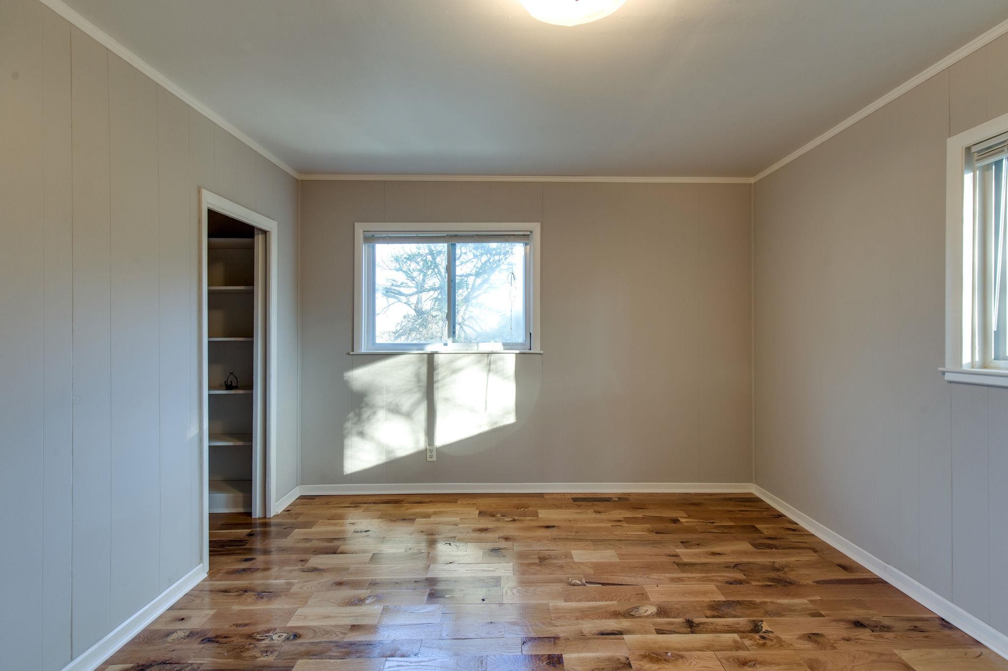 256 Manzano Road Madison, TN 37115 - Photo 11 of 24 an empty room with wooden floor and windows