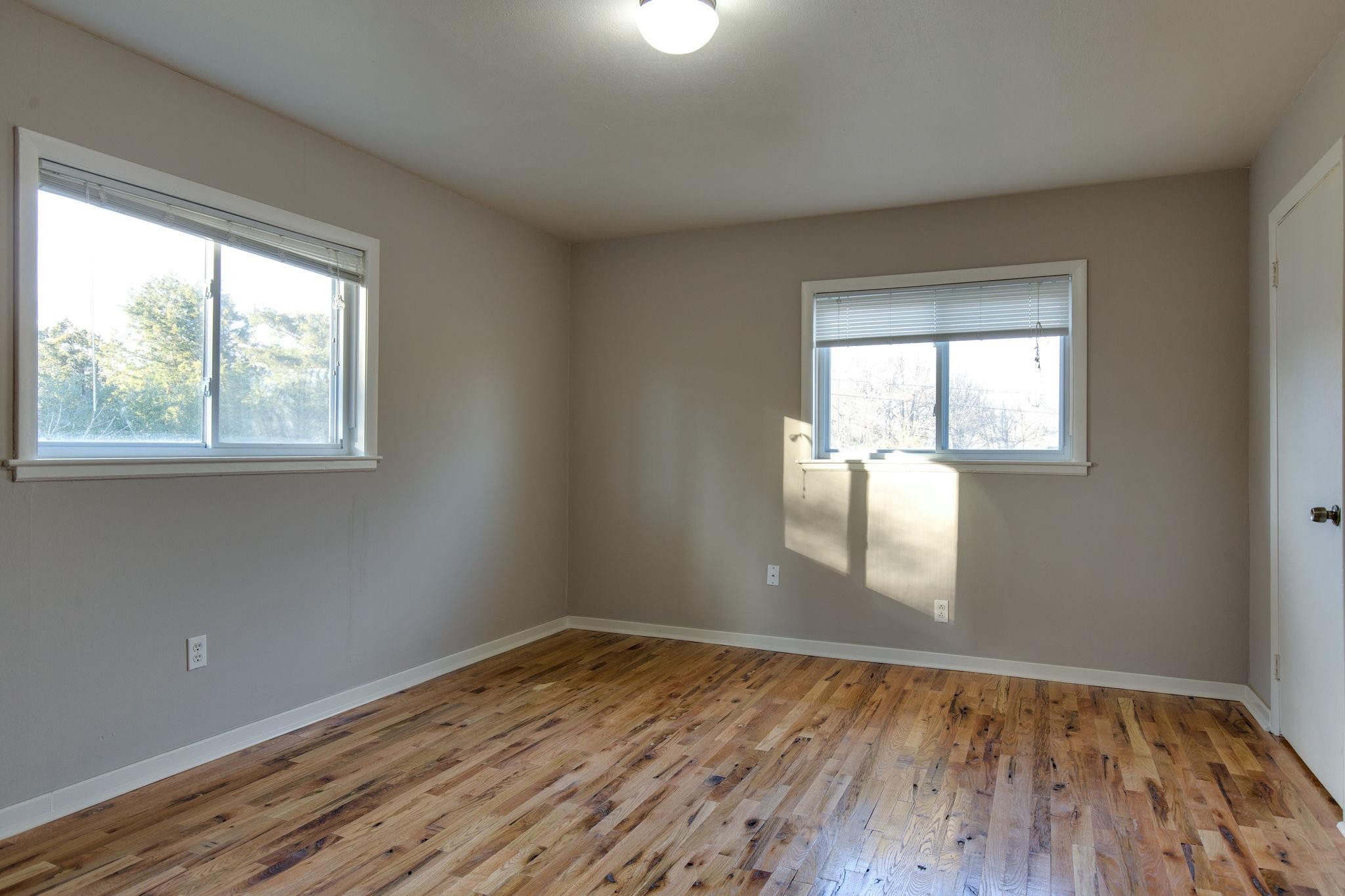 256 Manzano Road Madison, TN 37115 - Photo 13 of 24 an empty room that has wooden floor and windows